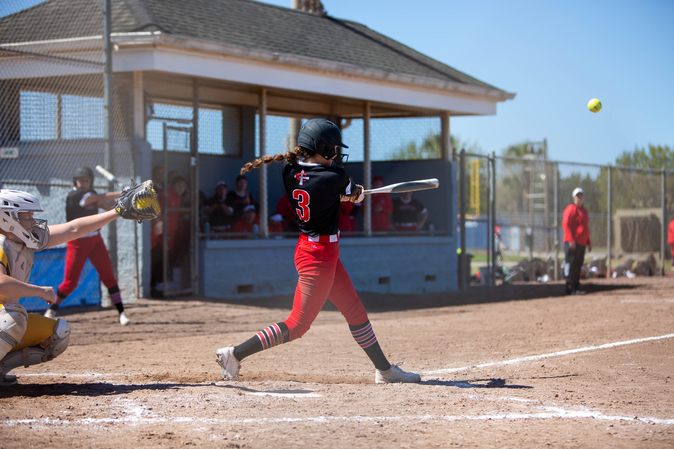 Softball splits a pair, while Lewis hits walk-off and Cavanagh gets win No. 100